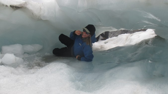 Creeping through an ice cave on Franz Joseph Glacier. 