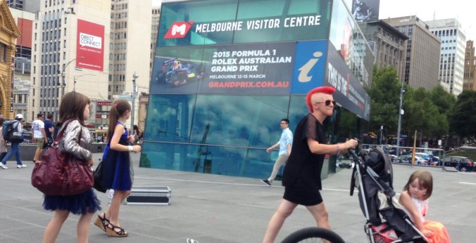 This sums up Melbourne perfectly - a woman with a red Mohawk pushes a stroller with a child in a princess dress. 