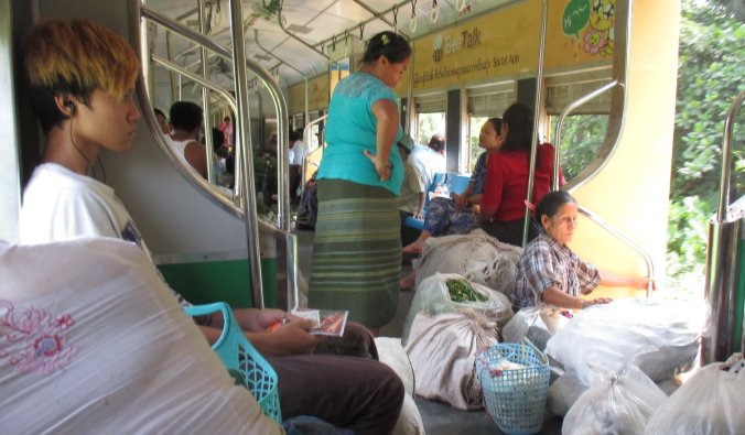 Passengers on the Yangon Circular Railway loaded down with goods from the vegetable market. 