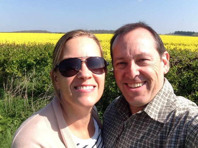 The loving couple next to the yellow field. 